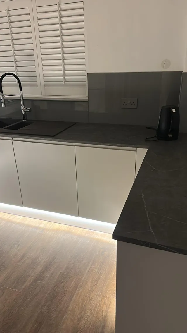 Handleless kitchen with LED plinth lighting installed by a local electrician
