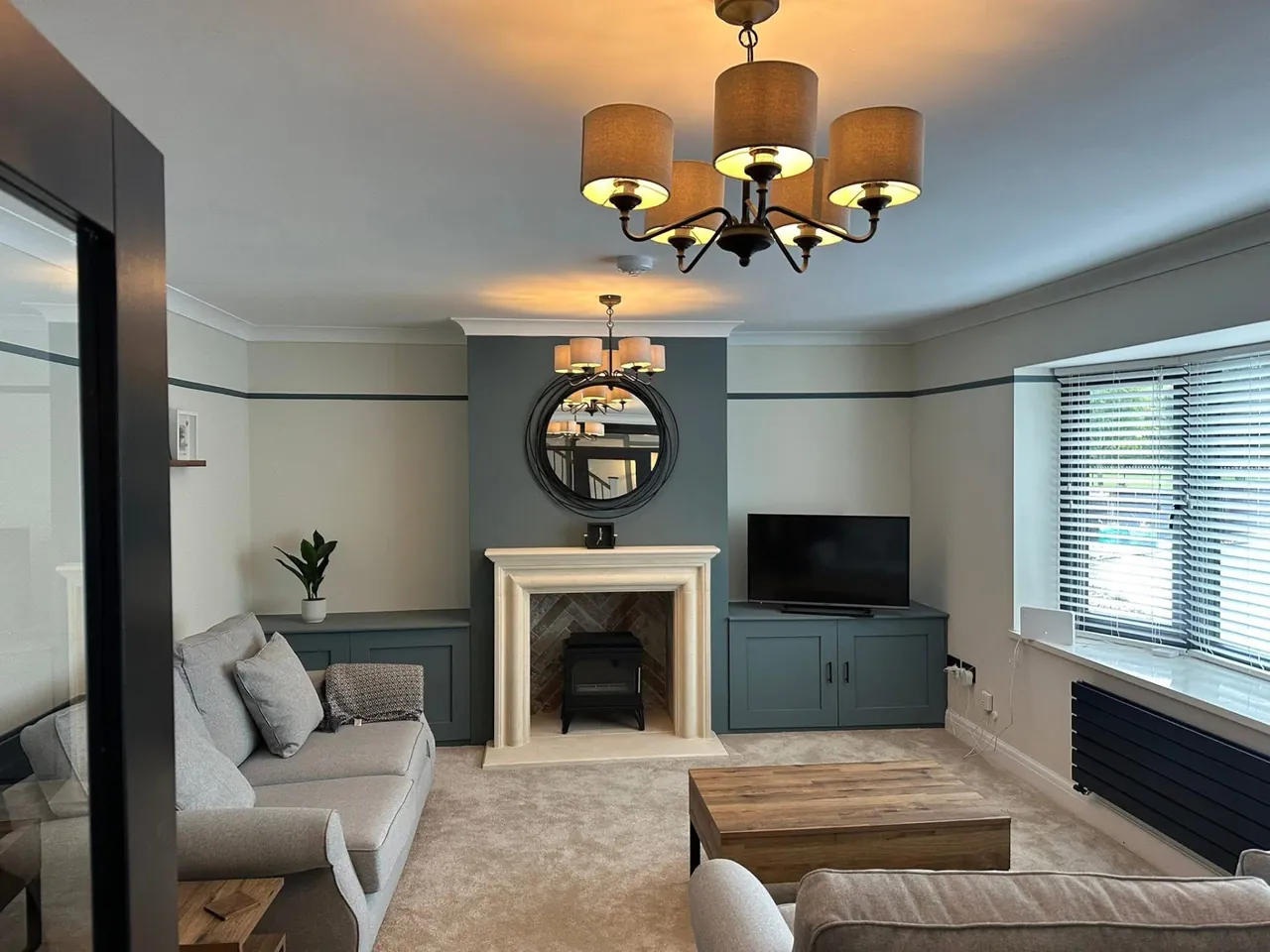 Living room lighting with a feature ceiling light installed in a family home